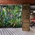 Stamba Hotel in Tbilisi with a lush indoor garden, patterned floor, and red lounge seating