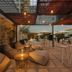 Hotel Vilamarí in Barcelona rooftop terrace with lounge seating, tables, and umbrellas at dusk