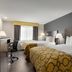 Baymont by Wyndham Branford/New Haven room with two double beds and a window desk in Branford