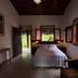 Pousada Morro dos Navegantes room in Ilhéus with bed, open windows and tropical garden view