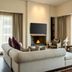 JW Marriott Hotel Bogota suite with fireplace, seating area, and floor-to-ceiling city views in Bogotá