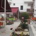 Hotel Baykal in Bogazkale courtyard with seating, potted flowers, and white building exterior