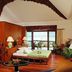 Badian Island Wellness Resort in Badian bedroom with sea view, wood furnishings, and balcony