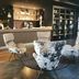 Parkhotel Horst lobby bar with modern lounge chairs and a wood-accented reception desk in Horst