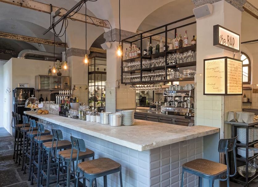 Alter Schlachthof in Bressanone/Brixen bar with long marble counter and shelves of bottles