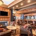 Hotel Bothwell Sedalia Central District lounge with fireplace, bar, and leather seating in Sedalia
