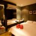 Justbeds Bangkok room with two beds, mirrored wall, and en suite bathroom visible