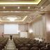 Euro Park Otel Istanbul conference hall with rows of chairs, podium, projection screen and ornate ceiling