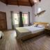 Blue World Dharavandhoo room in Dharavandhoo with wood ceiling, king bed, window, and fish wall decor
