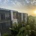 Sunset view of palm trees between buildings at Aqua Resort in Diani Beach