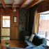 Cabañas Bordenieve in Termas de Chillan, cozy cabin interior with staircase, sofa, and wood-paneled walls