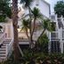Winslow's Bungalows in Key West with white wooden stairways, tropical palms, and bungalow exteriors