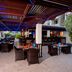 Outdoor dining area at The Apartments, Dubai World Trade Centre in Dubai with covered seating and table settings