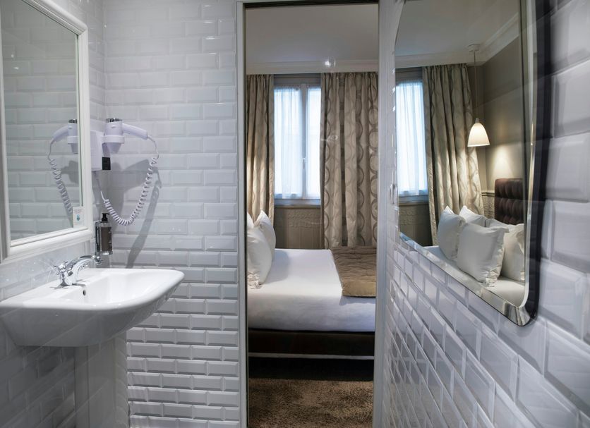 Hôtel Madeleine Haussmann, Paris bathroom with white subway tile and view into bedroom