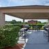 Sonesta Simply Suites Pittsburgh Airport outdoor covered seating area with tables and chairs