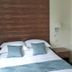 The Woodvale in Cowes bedroom with double bed, blue cushions, wood headboard and sunset wall art
