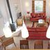 Village Cabo Girao in Câmara de Lobos living area with red sofas, coffee table and tiled floor