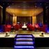 Howard Johnson by Wyndham Parkland Hotel Dalian lounge with red seating and blue-lit steps
