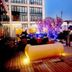 Howard Johnson by Wyndham Parkland Hotel Dalian rooftop terrace with lounge seating and city views