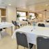 Caritas Oswald Cheung International House Hong Kong meeting room with tables, chairs, and water bottles