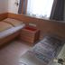 Hotel Planaiblick in Schladming guest room with two single beds, wood paneling and a window