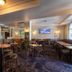 Royal Exhibition Hotel Sydney bistro-style lounge with tables, stools and wall-mounted TVs