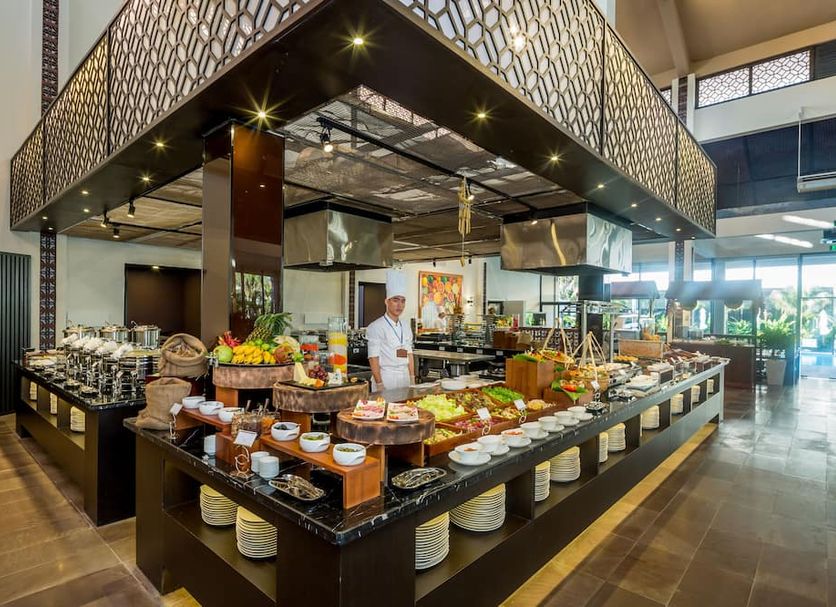 Grandvrio Ocean Resort Danang buffet station with assorted dishes and a chef in Dien Ban