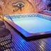 Pousada Alfa e Ômega in Alto Paraíso de Goiás features a small indoor pool with lounge cushions and wooden deck.