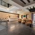 Áurea Toledo by Eurostars Hotel company lobby with patterned wall, seating area, and staircase in Toledo.