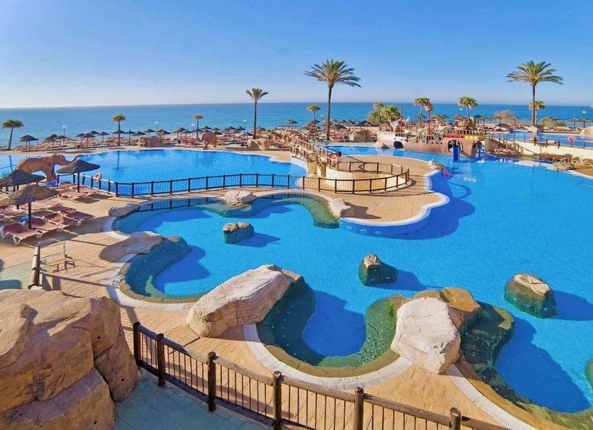 Holiday World Riwo Affiliated by Meliá in Benalmádena, large resort pool with palm trees and sea view