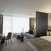 Der Öschberghof in Donaueschingen: modern hotel room with king bed, sofa and floor-to-ceiling windows