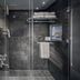 Yashshree Mall Road Darjeeling bathroom with glass shower, dark tile walls, and towel rack