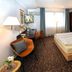 City-Hotel Aschaffenburg guest room in Aschaffenburg with bed, desk, chairs and window