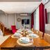 Bright Apart Hotel Istanbul dining area with set table, red chairs, staircase, and TV