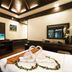 Ao Nang Orchid Resort in Krabi guest room with towel swans on bed and ceiling beams