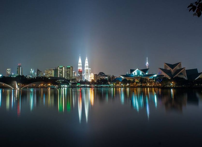 Riccarton Capsule Hotel, Kuala Lumpur skyline at night with lake reflections