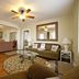 Desoto Beach Terraces in Tybee Island living room with sofa, glass coffee table, ceiling fan, and hardwood floors