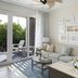 The Capitana Key West in Key West living room with sofa, coffee table and sliding doors to a balcony