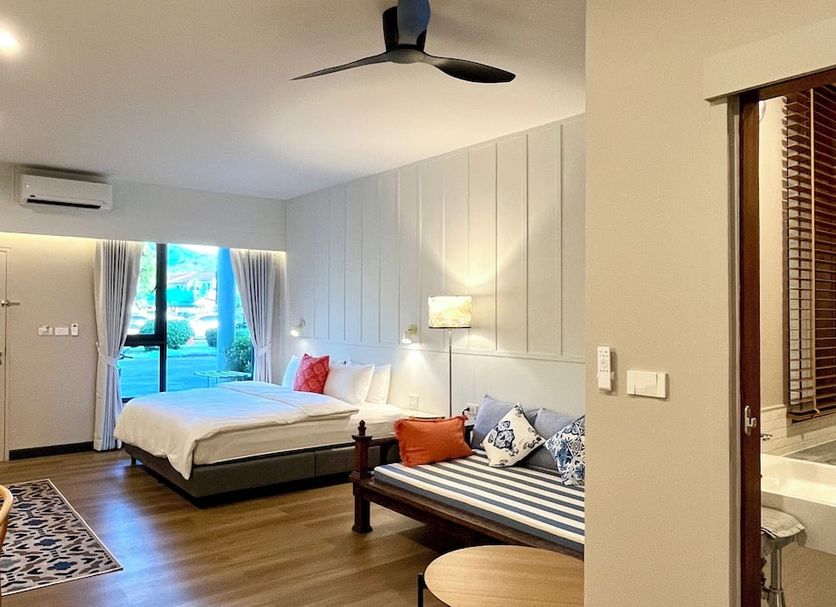 Nautical Home & Seashell House B&B in Khao Lak room with bed, sofa, ceiling fan and balcony view