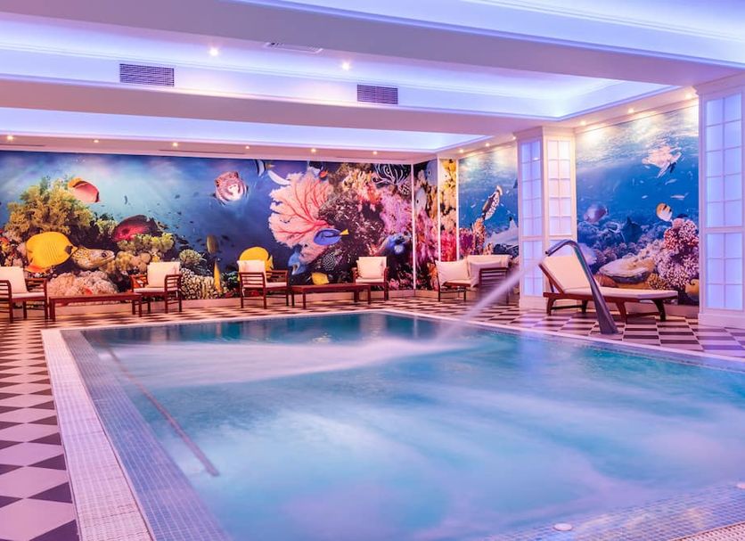 Grand Hotel Sofianu & Spa in Râmnicu Vâlcea indoor pool with underwater mural and lounge chairs