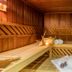 Achat Hotel Suhl sauna with wooden benches, candle, towels and massage tools in Suhl
