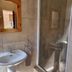 Emerald Guesthouse, Kempton Park: bathroom with sink, mirror, towel ring and glass shower enclosure