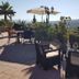 Casa Don Carlos in Alhaurín el Grande with terrace seating, umbrella, and hillside views