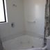193 Aorangi Manor Motel in Blenheim bathroom with corner spa tub, vanity sink and shower curtain