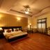 Hotel Waves, Delhi Airport room in New Delhi with king bed, wooden floor, ceiling fan and seating area