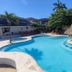 The Colonial at Jaguar Reef in Hopkins: tropical pool with thatched swim-up bar and palm trees