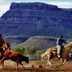 Grand Canyon Western Ranch in Meadview with guests horseback riding before a rugged canyon backdrop.