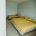 Tagüe in Gualeguaychú: simple guest room with two beds and tiled floor