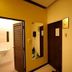 Bangrak Resort in Nakhon Sawan hallway with wall-mounted TV, mirror, sink, and bathroom door