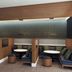 Courtyard by Marriott London lounge seating area with booths, round tables, and wood-paneled partitions